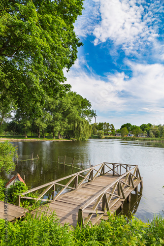 Landscape with a lake and a wooden bridge. Samchyky palace. Ukraine