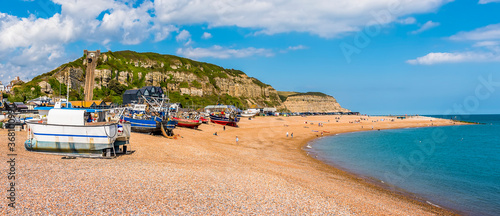 The curve of Hastings beach provides shelter of fishing boats in summer photo