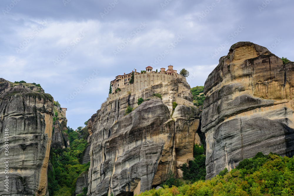 View of the stunning rock formations of Meteora and Holy Monastery of Varlaam. 