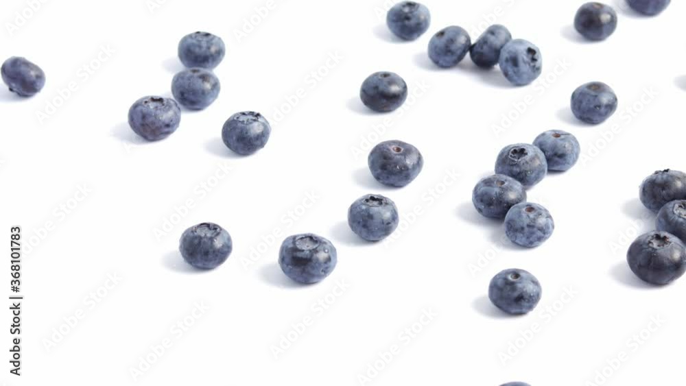 Blueberries falling from right side on a white background. Blueberries falling from right side on a white background.