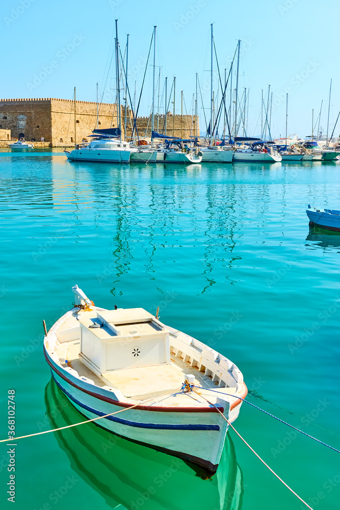 Fishing boat in the harbour near Koules Fortress in Heraklion Fishing boat in the harbour near Koules Fortress in Heraklion