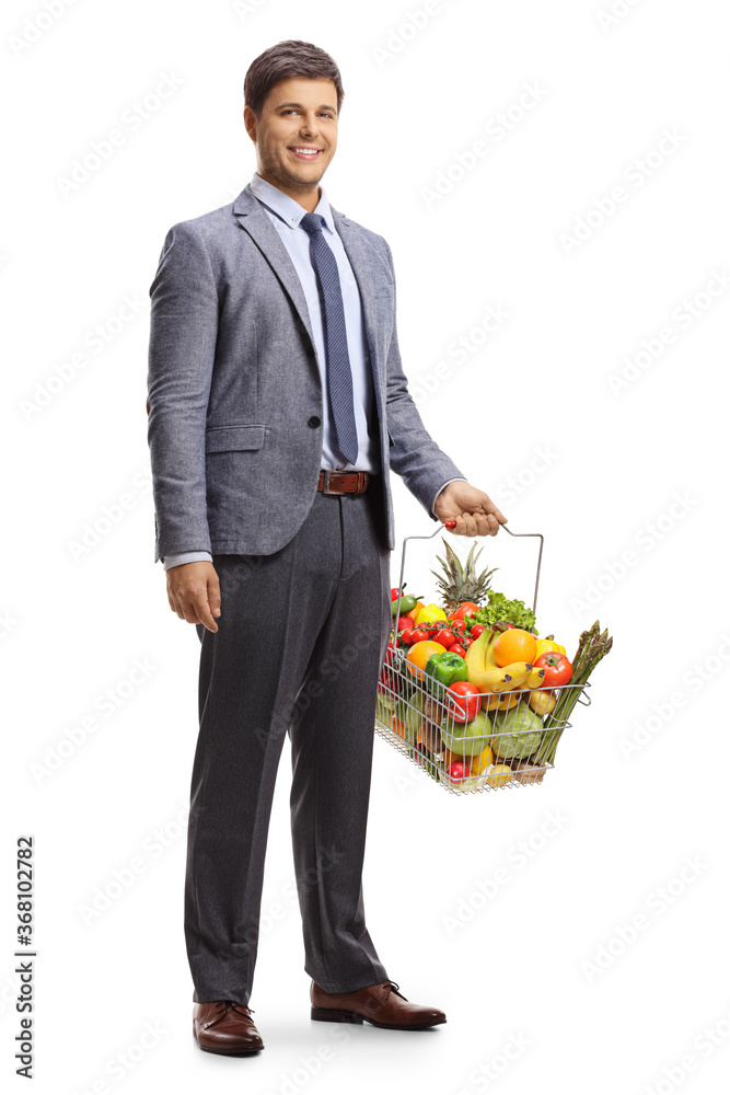 Full length portrait of a man in formal clothes with a shopping basket full of groceries Full length portrait of a man in formal clothes with a shopping basket full of groceries
