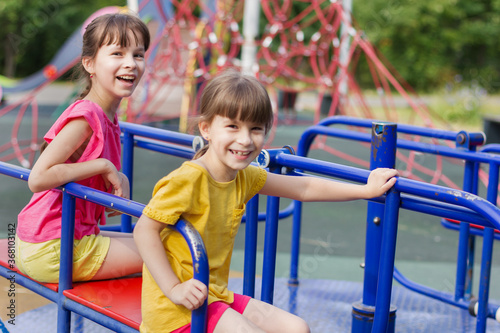 two little girls laughting on a playground