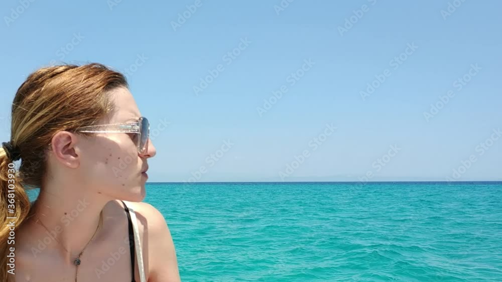 Girl on a speedboat, blue sea in the area of Pefkochori, Halkidiki, Greece Girl on a speedboat, blue sea in the area of Pefkochori, Halkidiki, Greece