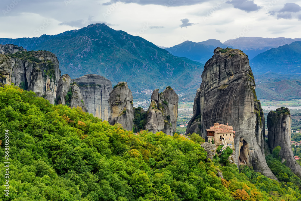 View of the stunning rock formations of Meteora and Holy Monastery of Rousanou. TheMonastery has received the name of the first probable hermit who settled on the rock.
