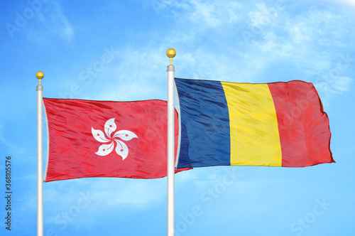 Hong Kong and Chad  two flags on flagpoles and blue cloudy sky photo