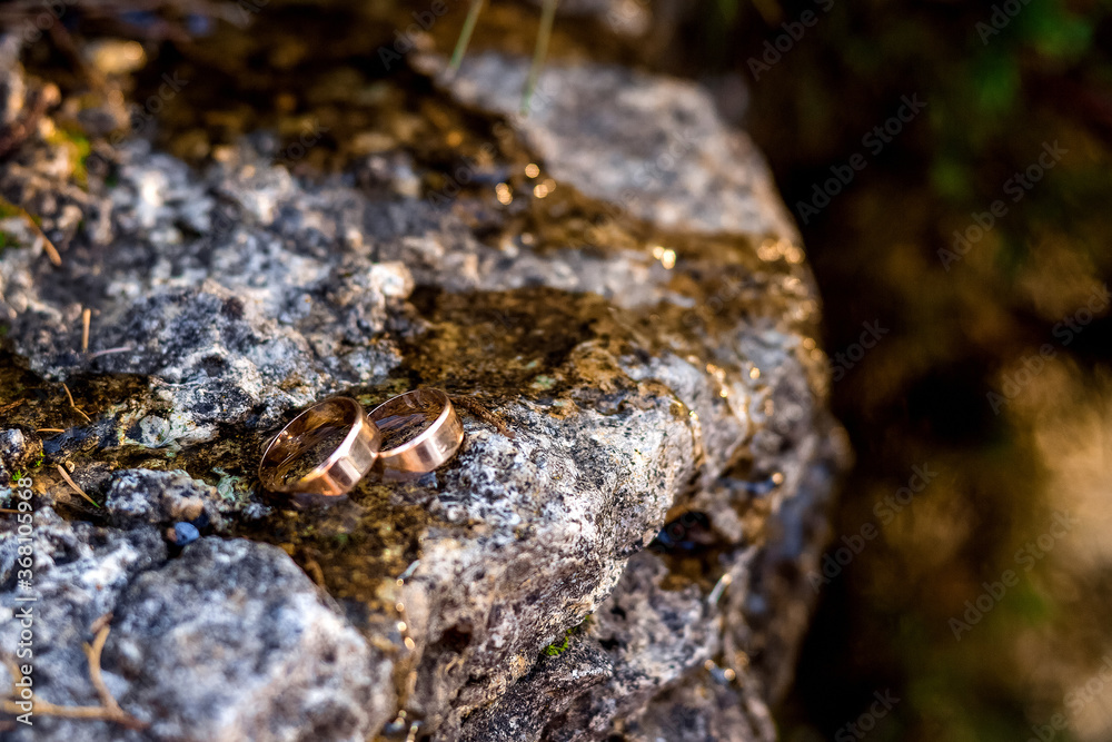 wedding rings on the edge of the waterfall.