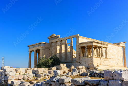 The Erechtheion is a temple in the Acropolis of Athens Honoring Athena and Poseidon, this famous, ancient Greek temple features a porch with 6 caryatids. 