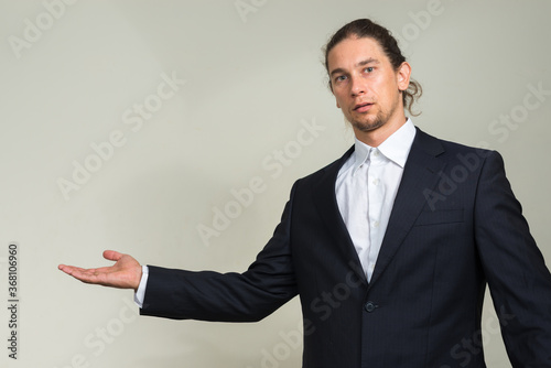 Portrait of handsome bearded businessman with long hair