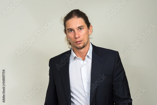 Portrait of handsome bearded businessman with long hair