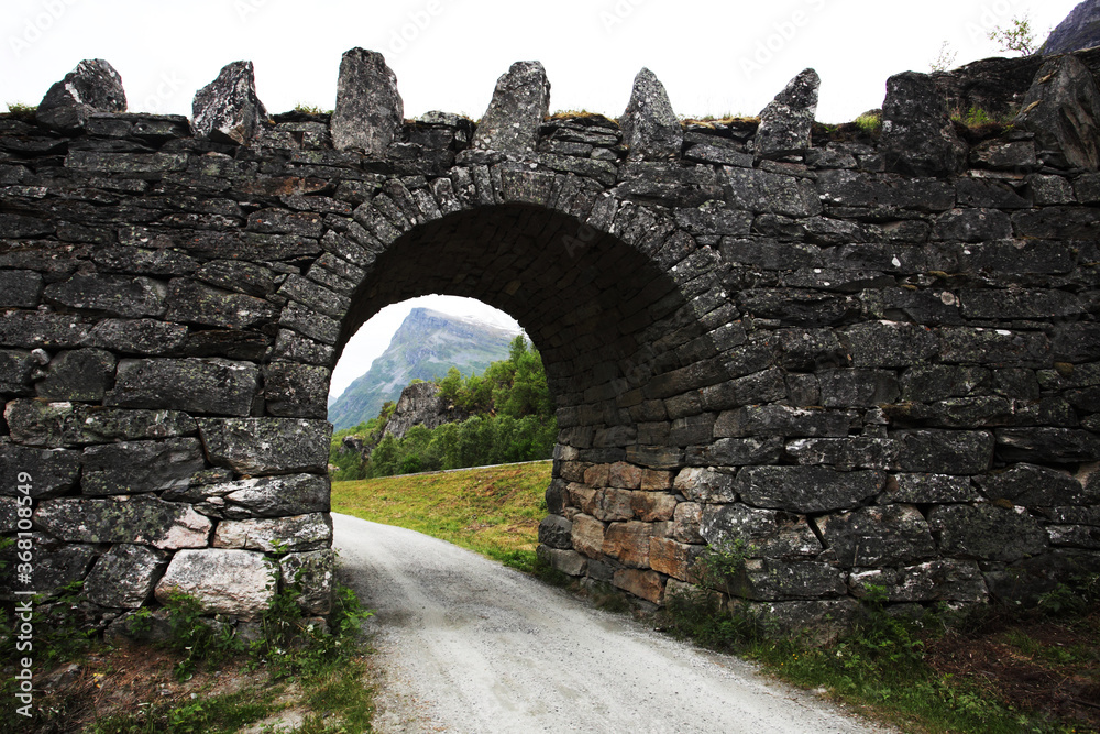 A Norwegian bridge over a small road in the countryside, Scandinavia.
