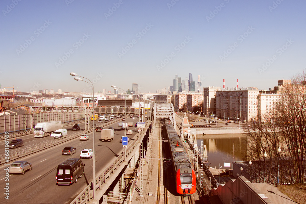 Apr 12, 2018. Moscow, Russia. Landscape  with Moscow International Business Center and Moscow Central Circle Railway with train