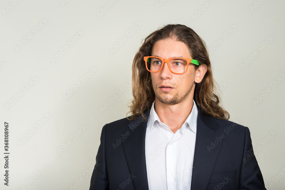 Portrait of handsome bearded businessman with long hair