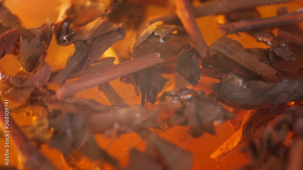 Tea leaves float in the water. Brew tea. Herbal tea in a glass. Tea leaves float in the water. Brew tea. Herbal tea in a glass.