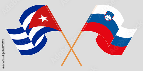 Crossed and waving flags of Cuba and Slovenia