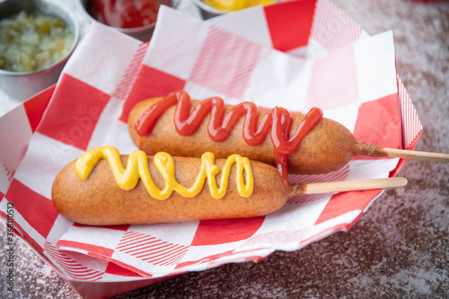 Canvas Print corn dog with ketchup and yellow mustard