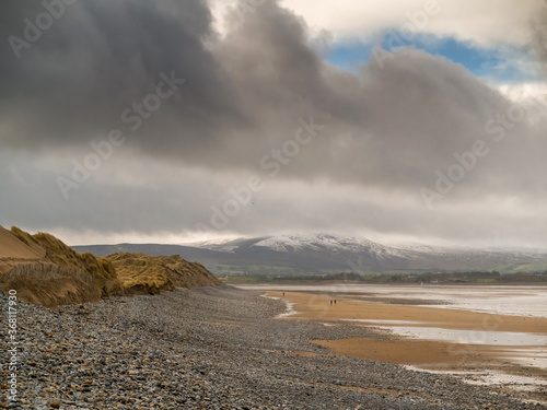 Beautiful Strandhill beach in county Sligo  Ireland Dramatic sky. Mountains in the background covered with snow. Winter season. Low tide.