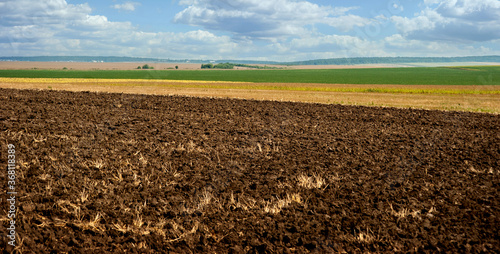 Beautiful black earth fields in Ukraine. Agricultural rural landscape, colorf...