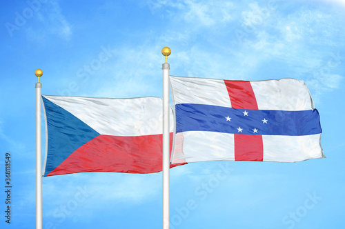 Czech and Netherlands Antilles two flags on flagpoles and blue cloudy sky