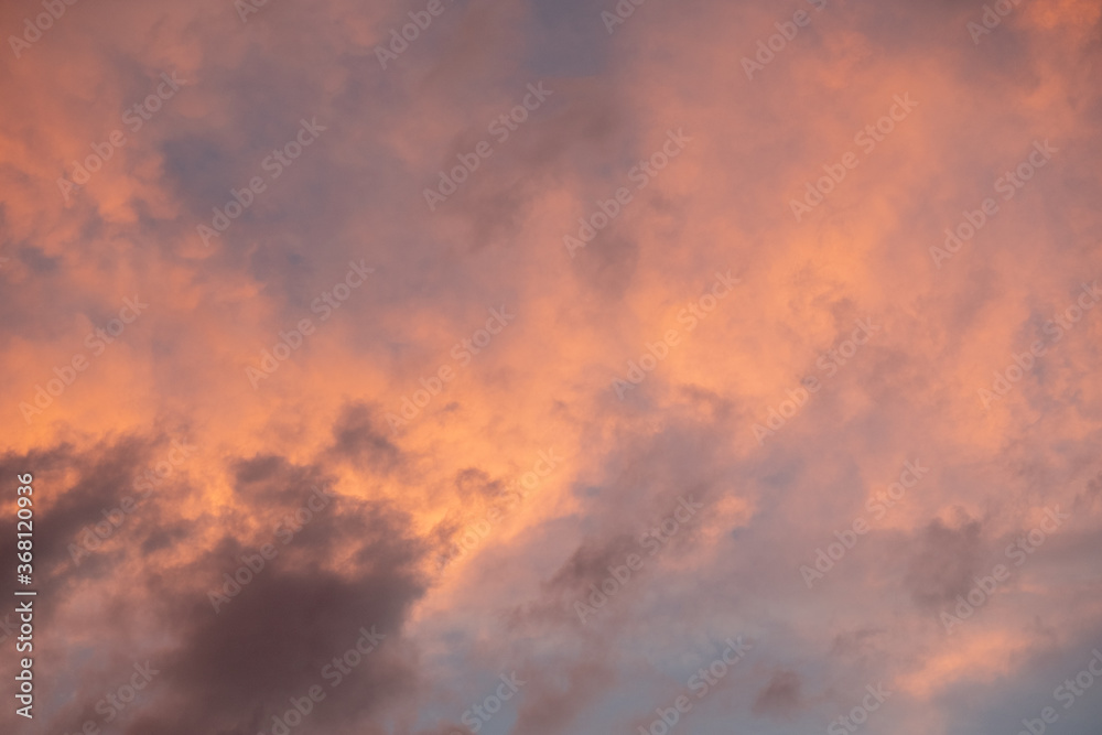 Pink sunset after rain. Black, thunderclouds and blue sky. Sunset at the sea. Summer. Georgia.