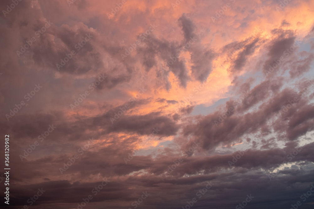 Fototapeta premium Pink sunset after rain. Black, thunderclouds and blue sky. Sunset at the sea. Summer. Georgia.
