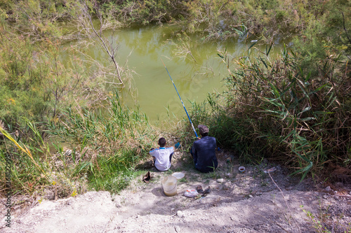 Two Fishermen by the River