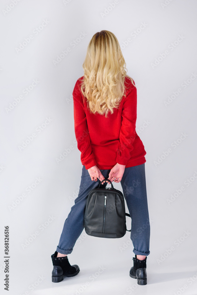 girl posing with a backpack in the studio girl posing with a backpack in the studio