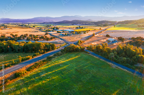Drone photo of crossroads and field in early morning sunset © Stewart