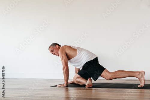 Senior man doing yoga stretching