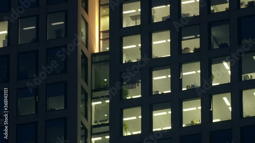 Locked down evening shot of a modern office building with some lights turned on. Frankfurt, Germany.