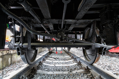 View under the old train on wheels.