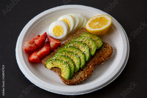toasted sandwich with avocado,  egg, strawberry and lemon