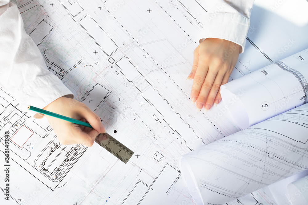 architect designer working on architectural blueprints, building plans in the office, drawing architect designer working on architectural blueprints, building plans in the office, drawing