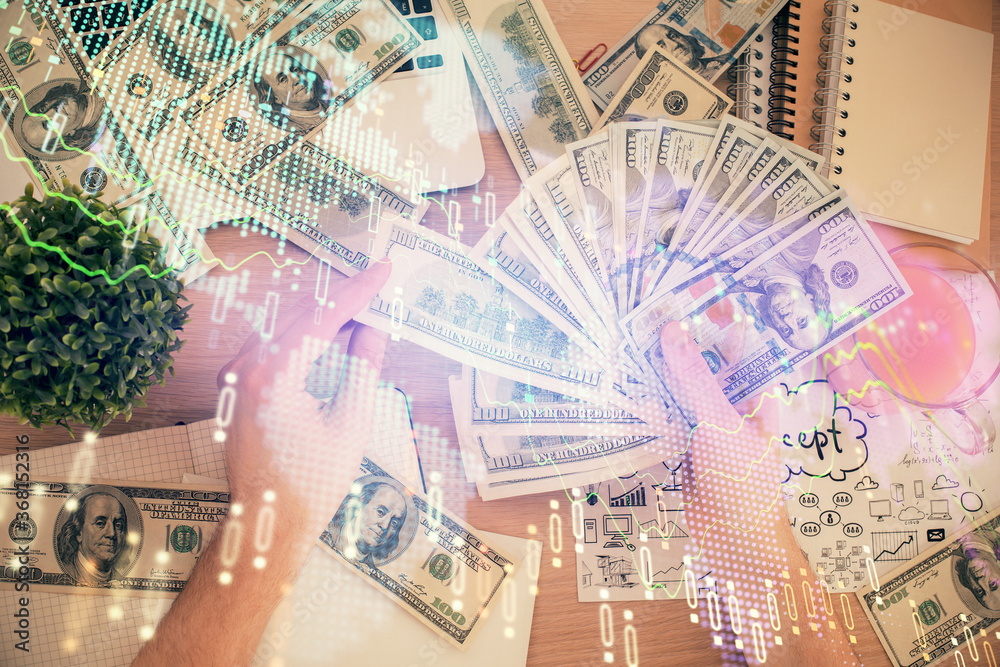 Multi exposure of financial graph drawing hologram and USA dollars bills and man hands. Analysis concept. Multi exposure of financial graph drawing hologram and USA dollars bills and man hands. Analysis concept.
