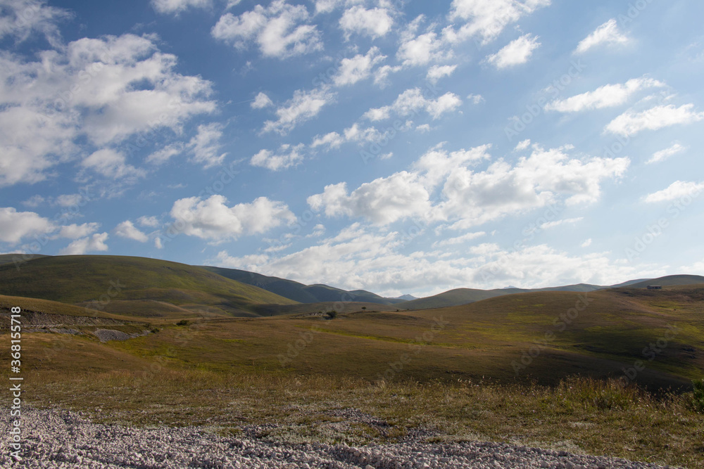 Rolling hills with fluffy clouds on background, Italy. Rolling hills with fluffy clouds on background, Italy.