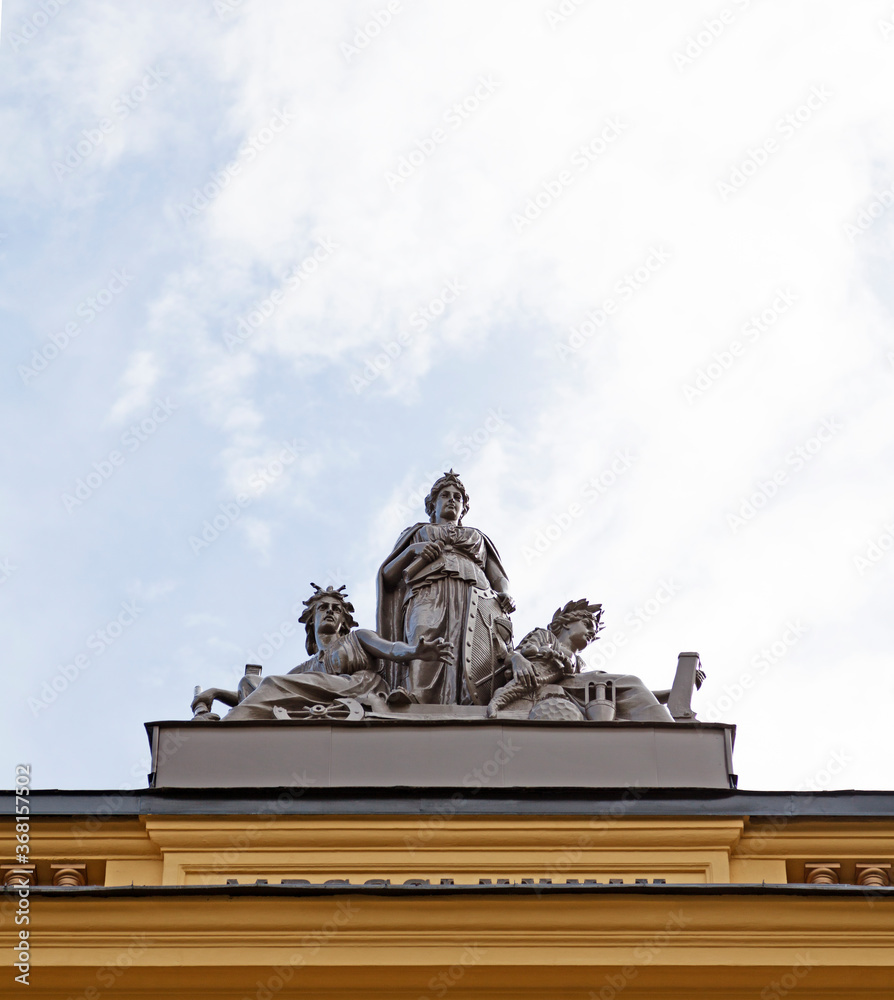 Sundsvall, Norrland Sweden - July 14, 2020: statues with antique motifs on the roof of an old stone house