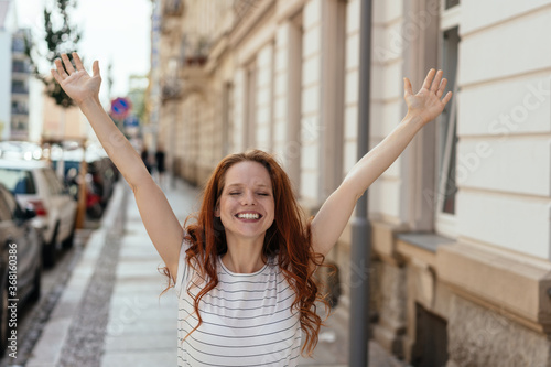 Young woman celebrating with outstretched arms
