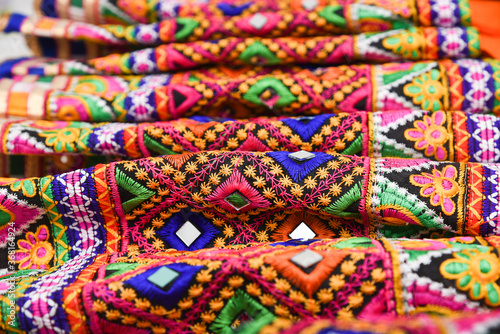 Colourful Indian traditional ethnic ware for woman or girls Gujarat, India. Handmade tribal skirt with embroidery, mirror work. Wedding dress of rural women. multi color design party wear, Rajasthan. photo
