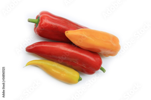 Red, orange and yellow fresh long peppers isolated on white background. Summer vegetables 