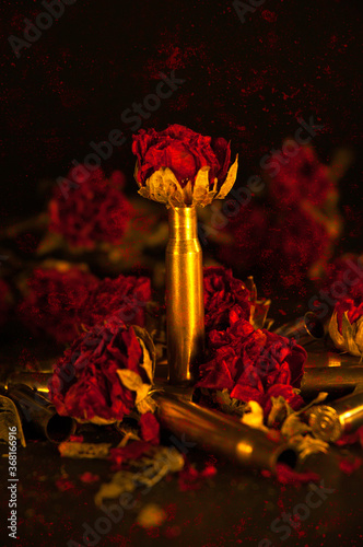 Grunge - Brass bullet casings and dried roses with grunge texture.