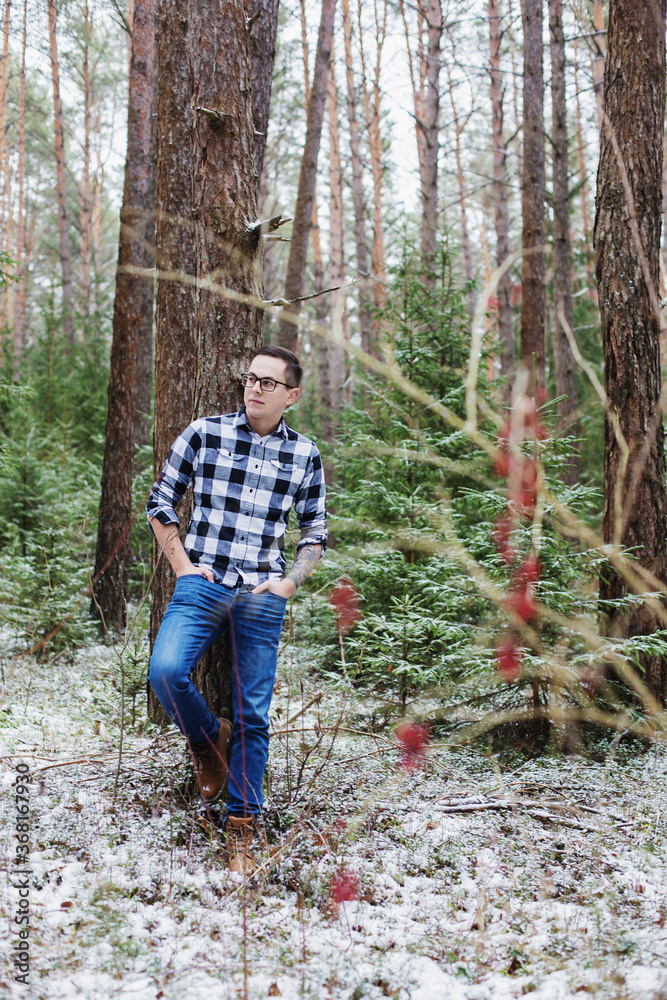 young man in winter forest young man in winter forest