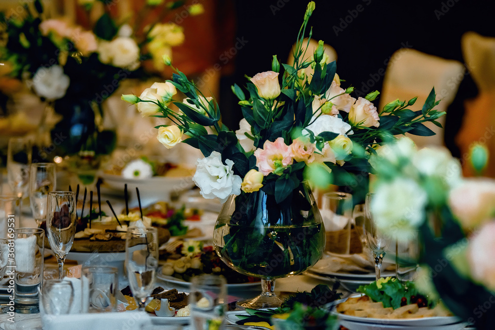 Beautiful bouquet of flowers at the wedding table in a restaurant for holidays and wedding dinner