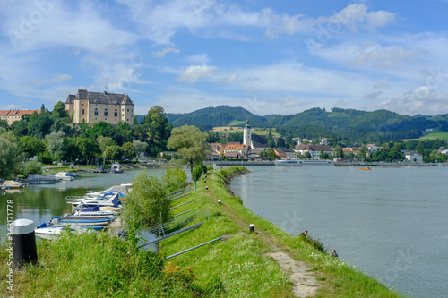 city of grein with castle greinburg at the danube river in austria photo