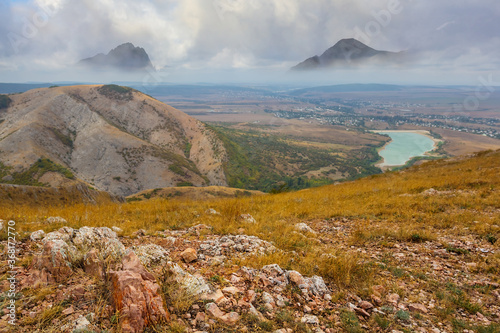 view from a mountain plateau to a snowbound mountain ridge