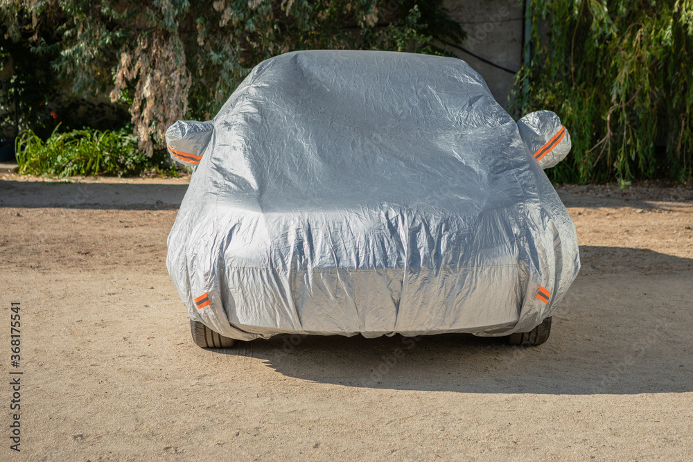 The car is in the parking with auto cover from the sun. Protection from heating the car.