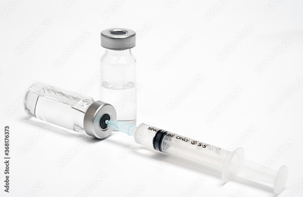 Vaccine concept with syringe and ampoule on white background. Vaccine concept with syringe and ampoule on white background.