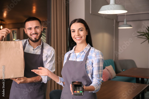 Young waiters with food for...