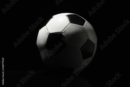 Soccer ball on dark background © Pixel-Shot