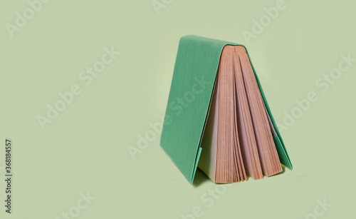 One book in a color cover is on a uniform background