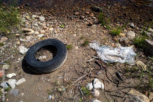 car tyre and piece of plastic on shore